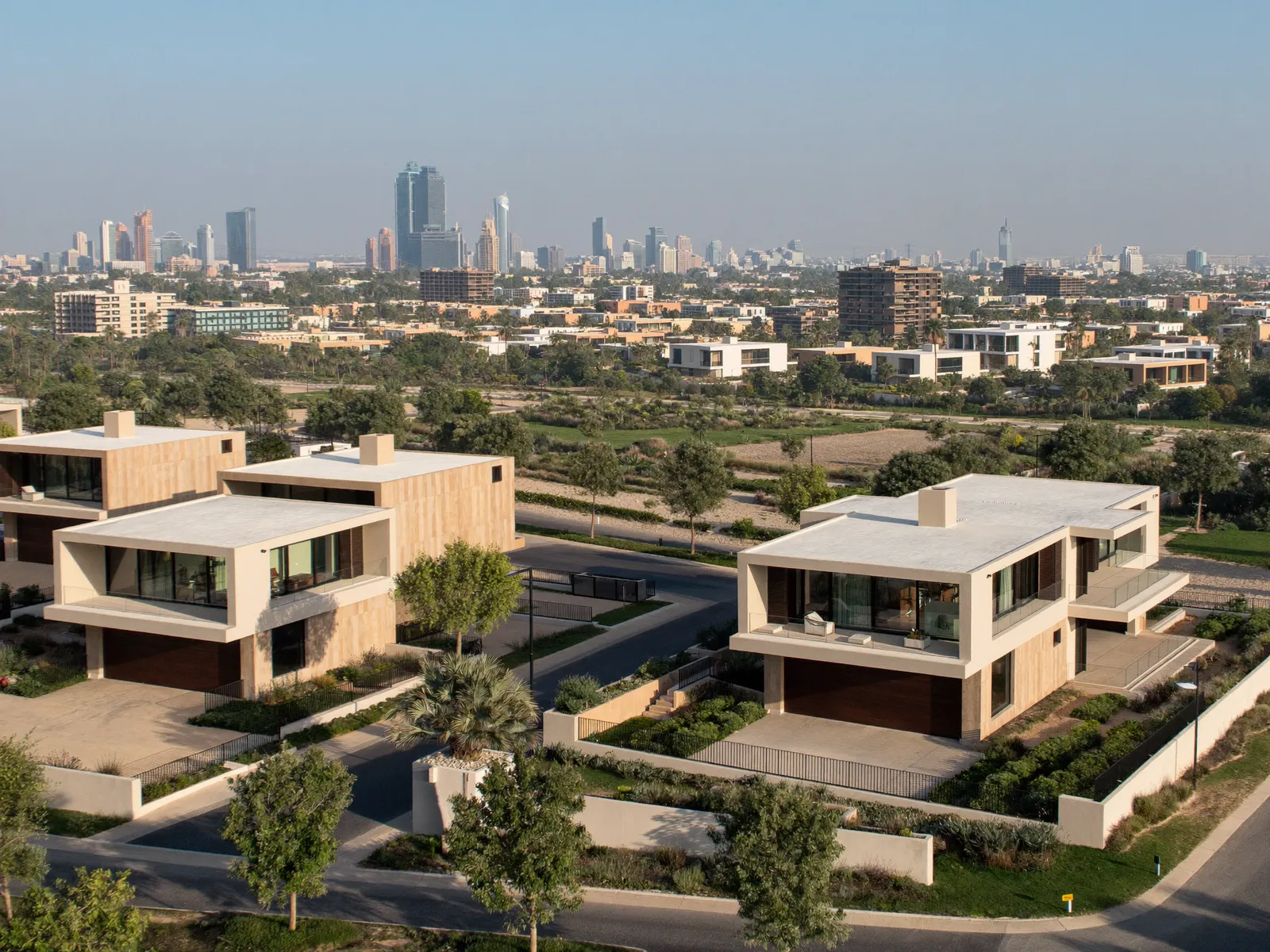 Modern townhouses and villas beside a golf course in Damac Hills, Dubai