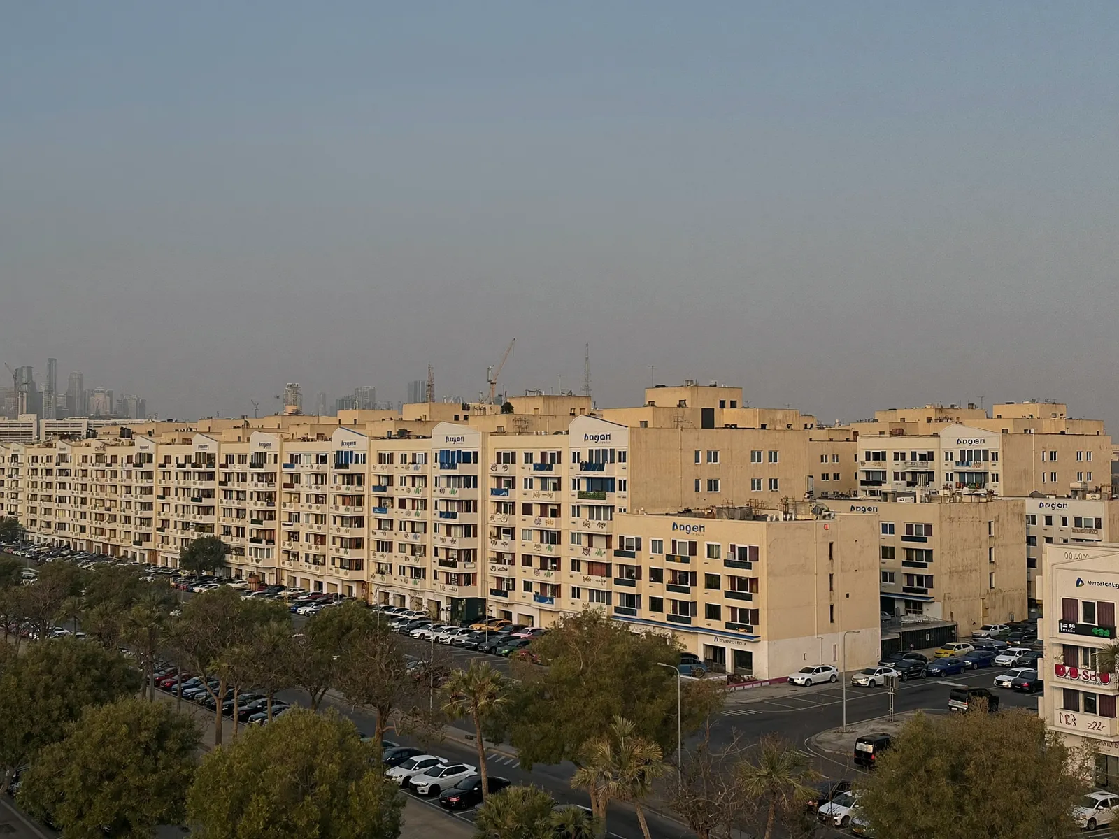 Rows of low-rise apartment buildings with themed facades in International City